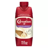 Front Center view of NESTLE CARNATION Lactose Free 11oz Tetra Carton NET / NETO 11 fl oz (325 mL) product.