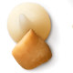 White chocolate morsel next to a macadamia.